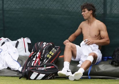 Rafael Nadal changes his shirt during a training session at Wimbledon in London on Saturday.