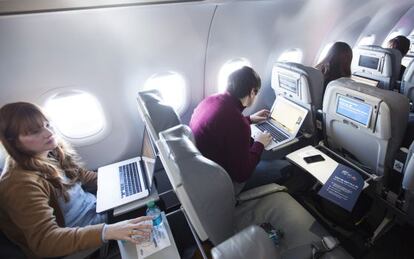 Journalists trying wi-fi service aboard a JetBlue airplane.