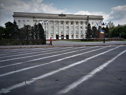 A woman in the deserted streets of downtown Kherson, the target of daily attacks.