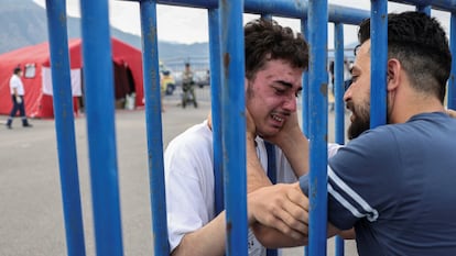 Syrian survivor Fedi, 18, cries as he reunites with his brother Mohammad, who came to meet him from Italy, at the port of Kalamata.