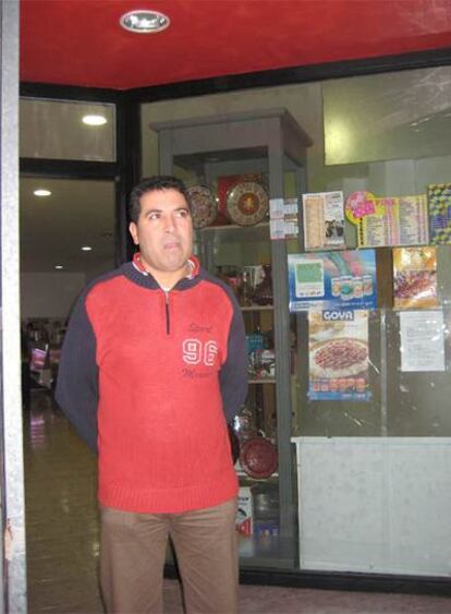 El marido de la mujer atacada, ante la tienda que ambos regentan.