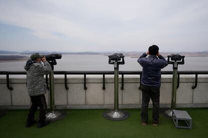 Visitors use binoculars to see the North Korean side from the unification observatory in Paju, South Korea, Tuesday, March 14, 2023.