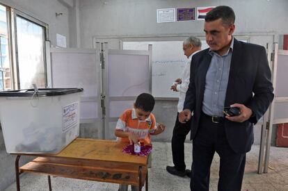 Um homem junto de filho após votar em um centro eleitoral do Cairo.