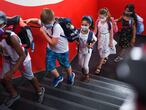 Students with face masks go upstairs to their classrooms at the Petri primary school in Dortmund, western Germany, on August 12, 2020, amid the novel coronavirus COVID-19 pandemic. - Schools in the western federal state of North Rhine-Westphalia re-started under strict health guidelines after the summer holidays. (Photo by Ina FASSBENDER / AFP)