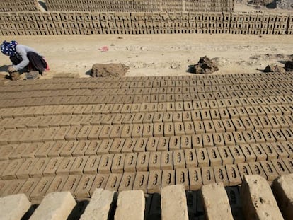 Dos mujeres indias trabajan en una producci&oacute;n de ladrillos, en la v&iacute;spera del D&iacute;a Internacional de la Mujer.