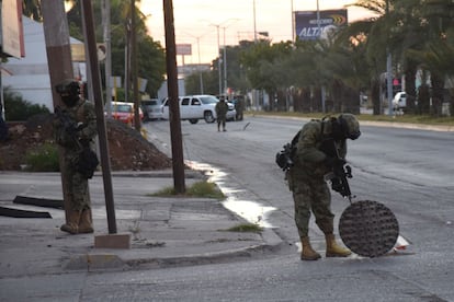 A Mexican navy marine inspects an open manhole after the recapture of Mexico's most wanted drug lord, Joaquin 'El Chapo' Guzman in the city of Los Mochis, Mexico, Friday, Jan. 8, 2016. The world�s most-wanted drug lord was captured for a third time, as Mexican marines staged heavily-armed raids that caught Guzman six months after he escaped from a maximum security prison.(Kiko Guerrero via AP/EL DEBATE)