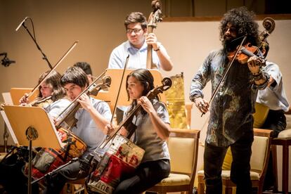 El violinista Ara Malikian junto a la orquesta de Cateura y 'La Música del reciclaje' en uno de los conciertos ofrecidos en las navidades de 2015 en España.