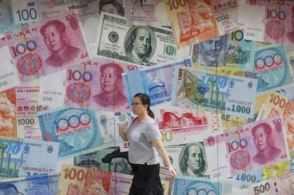 Una mujer pasa junto a una oficina de cambio en Hong Kong.
