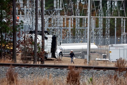 Workers work on equipment at the West End Substation, at 6910 NC Hwy 211 in West End, N.C., Dec. 5, 2022.