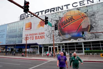 Fans walks past the Footprint Center, Tuesday, March 14, 2023, in Phoenix.