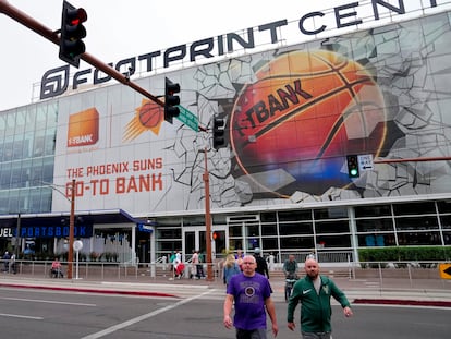 Fans walks past the Footprint Center, Tuesday, March 14, 2023, in Phoenix.