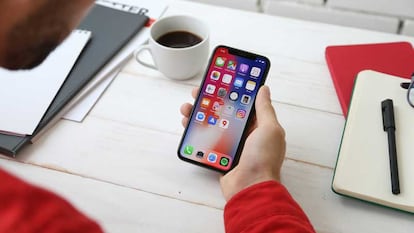 Uso de un iPhone de Apple con una mano y mesa