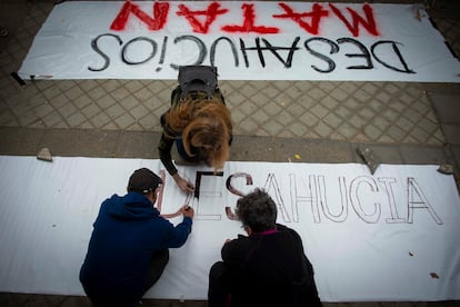 Tres personas pintan carteles durante un acto organizado por el Sindicato de Inquilinas, el domingo pasado en la Plaza de Peñuelas, Madrid.