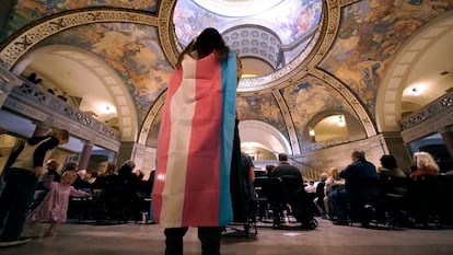 Glenda Starke wears a transgender flag as a counter protest during a rally in favor of a ban on gender-affirming health care legislation, March 20, 2023, at the Missouri Statehouse in Jefferson City.
