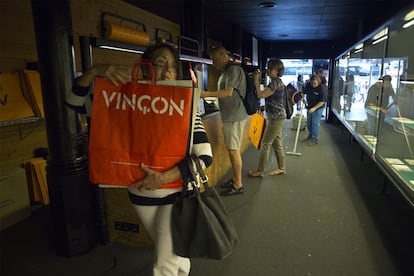 Una clienta de Vinçon coge varias de las bolsas que han formado parte de la historia del comercio.