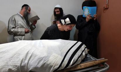 Familiares de un militar israelo-canadiense muerto en el ataque de un palestino en Jerusalén lloran junto al cadáver.