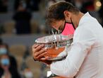 Spain's Rafael Nadal holds the trophy as he celebrates winning the final match of the French Open tennis tournament against Serbia's Novak Djokovic in three sets, 6-0, 6-2, 7-5, at the Roland Garros stadium in Paris, France, Sunday, Oct. 11, 2020. (AP Photo/Christophe Ena)