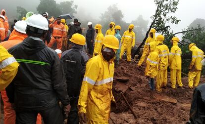 National Disaster Response Force (NDRF) personnel along with others perform a rescue operation after a landslide in Irshalwadi village in Raigad district, Maharashtra, India, 20 July 2023.