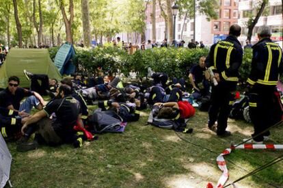 Varias decenas de bomberos del Ayuntamiento de Madrid acampados en el paseo del Prado.