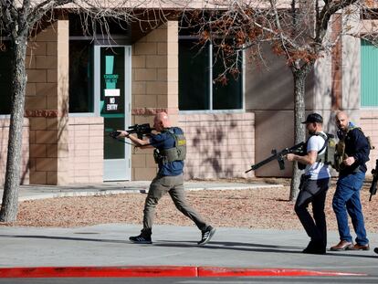 Law enforcement officers head into the University of Nevada, Las Vegas, campus after reports of an active shooter, Wednesday, Dec. 6, 2023, in Las Vegas