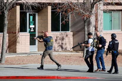 Law enforcement officers head into the University of Nevada, Las Vegas, campus after reports of an active shooter, Wednesday, Dec. 6, 2023, in Las Vegas
