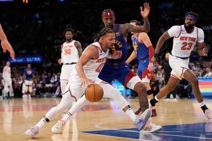 New York Knicks guard Jalen Brunson (11) drives against Denver Nuggets guard Kentavious Caldwell-Pope (5) during the second half of an NBA basketball game, Saturday, March 18, 2023, at Madison Square Garden in New York.