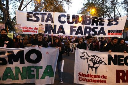 Protesters from the student union hold a banner with the message: “This summit is a farce.”