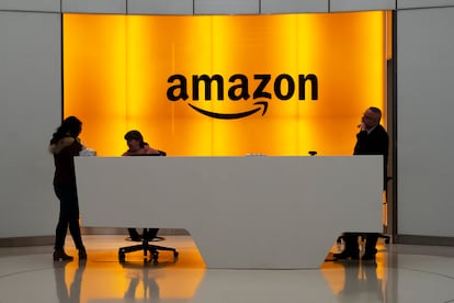 People stand in the lobby for Amazon offices in New York.