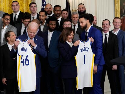 President Joe Biden and Vice President Kamala Harris hold up team jerseys as they welcome the 2022 NBA champions, the Golden State Warriors, to the East Room of the White House in Washington, Tuesday, Jan 17, 2023.