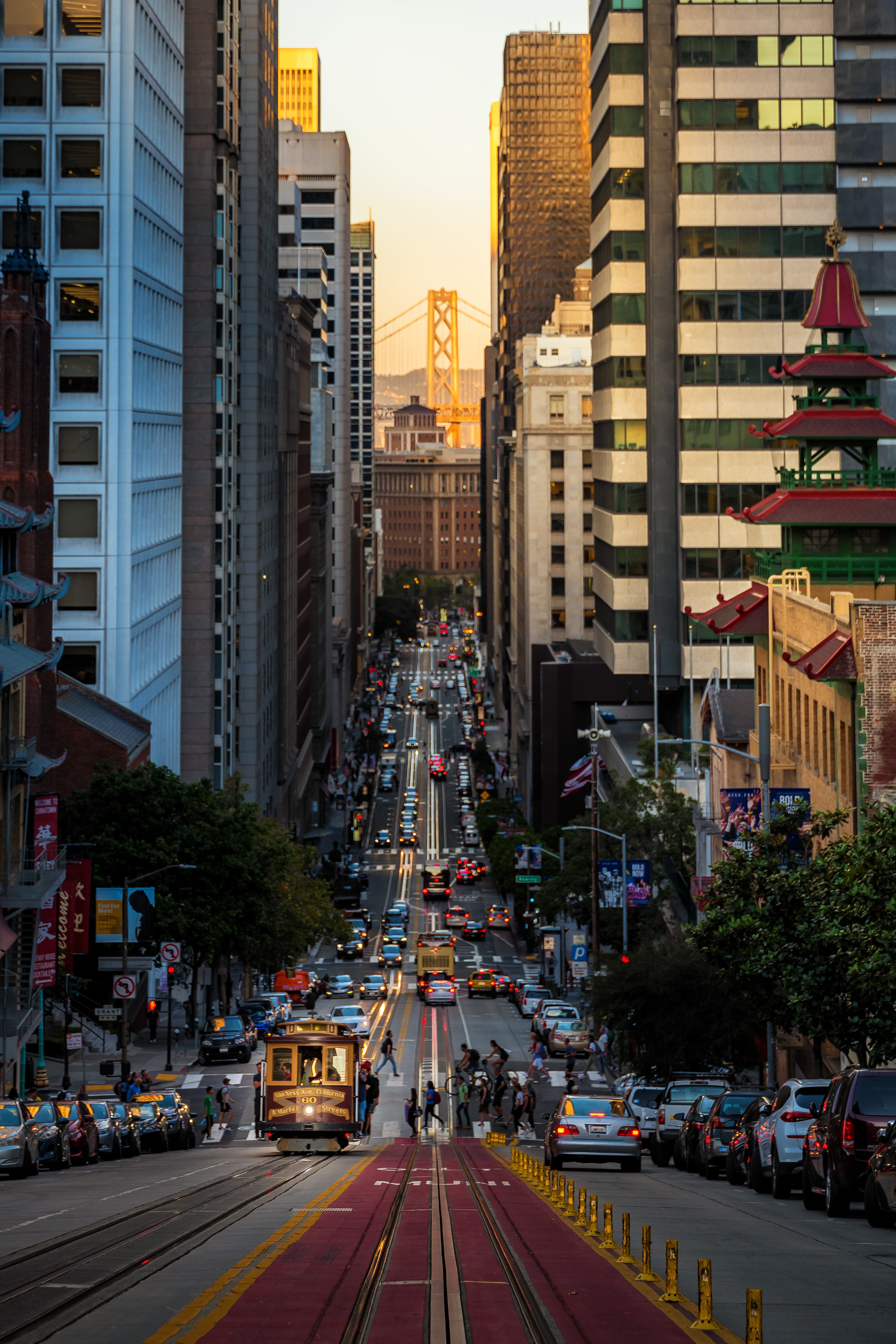 Un tranvía recorre la California Street de San Francisco, con el puente Golden Gate al fondo.