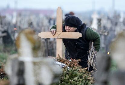 Una mujer besa la cruz de un pariente fallecido en un cementerio a 50km al suroeste de Bucarest (Rumania), el 5 de abril de 2018.