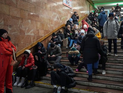 People rest in the subway station, being used as a bomb shelter during a rocket attack in Kyiv, Ukraine, Friday, Dec. 16, 2022. Ukrainian authorities reported explosions in at least three cities Friday, saying Russia has launched a major missile attack on energy facilities and infrastructure. Kyiv Mayor Vitali Klitschko reported explosions in at least four districts, urging residents to go to shelters. (AP Photo/Efrem Lukatsky)