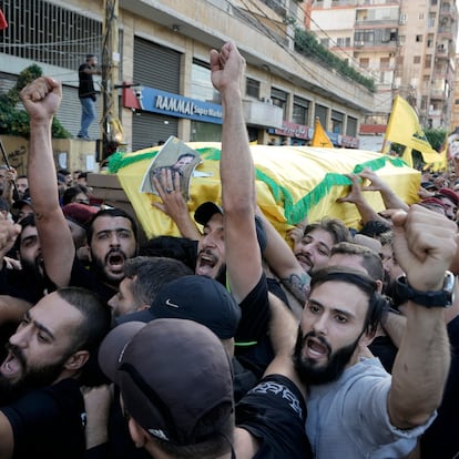 Hezbollah members carry the coffins of their comrades who were killed in Friday's Israeli strike, during their funeral procession in the southern suburb of Beirut, Saturday, Sept. 21, 2024. (AP Photo/Bilal Hussein)