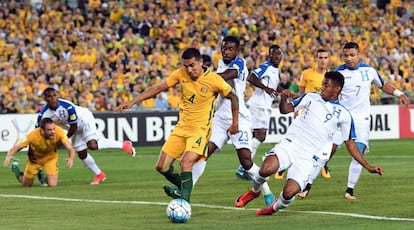 El australiano Tim Cahill disputa el balón ante la zaga hondureña.