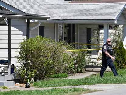A Louisville Metro Police officer walks outside of the home of the suspected shooter in the Camp Taylor neighborhood in Louisville, Ky., Monday, April 10, 2023