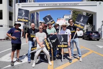 Cast and writers from "Breaking Bad" and "Better Call Saul" Juan Carlos Cantu, from left, Javier Grajeda, Aaron Paul, Charles Baker, Norma Maldonad, Jesse Plemons, Peter Gould, Bryan Cranston and Matt Jones, pose on a picket line outside Sony Pictures studios on Tuesday, Aug. 29, 2023, in Culver City, Calif.