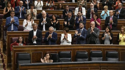 Members of Congress applauding after the vote.