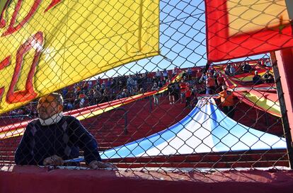 Un hincha del Club Deportivo Español, con banderas argentinas y españolas cubriendo las gradas.