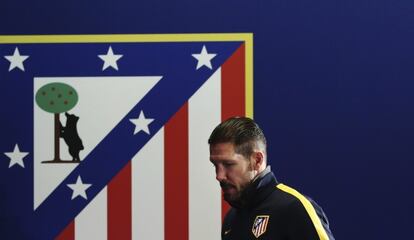 Simeone, junto a un escudo del Atlético.
