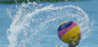 El kazajo Ukumanov sostiene el balón de water polo en el partido de la fase de grupos contra España.