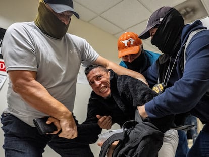 ICE agents detain a migrant as he leaves his court hearing in Manhattan, New York