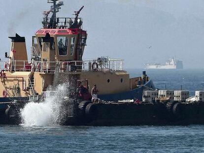 A Gibraltarian tug dumps concrete slabs into the water close to the colony&#039;s airport last month.