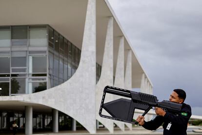 Un elemento de seguridad usa un arma anti-drones contra un aparato que volaba cerca de Planalto, este lunes.