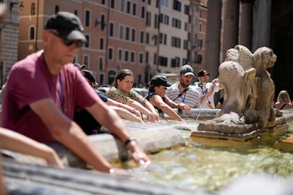 People cool off at a fountain in front of the Pantheon, in Rome, Saturday, Aug. 19, 2023