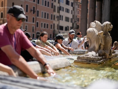 People cool off at a fountain in front of the Pantheon, in Rome, Saturday, Aug. 19, 2023