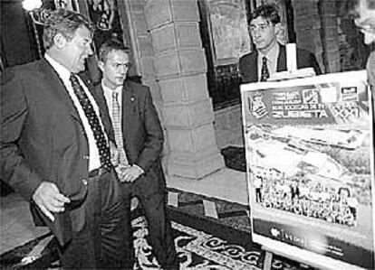 Toshack contempla el cartel junto a Astiazarán, presidente de la Real. Al fondo, Loren.