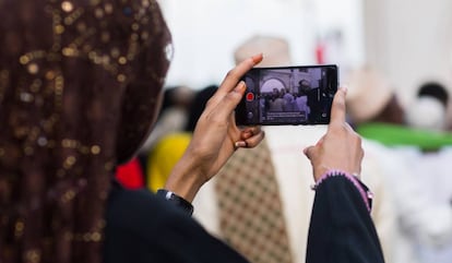 Una mujer hace fotograf&iacute;as con su &#039;smartphone&#039; durante las fiestas Maulidi en Kenia. 
 
 