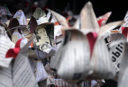 Una fotografía de la periodista rusa Anna Politkóvskaya entre flores de papel durante un acto de conmemoración del octavo aniversario de su asesinato, en Moscú, Rusia.