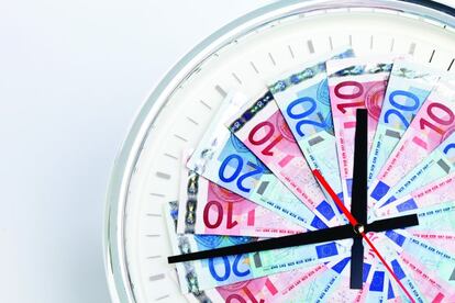 Fotocomposi&oacute;n de una ruleta, un reloj y dinero. 