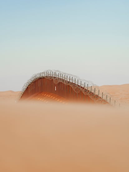 The undulating border wall floats above the dunes of the Algodones Desert in California. The foundation-less wall literally floats above the sand, adapting to the changes in the undulations of the terrain, constantly moved by the wind.